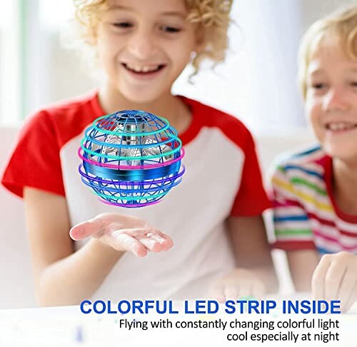 Children playing with a colorful LED floating toy drone indoors.